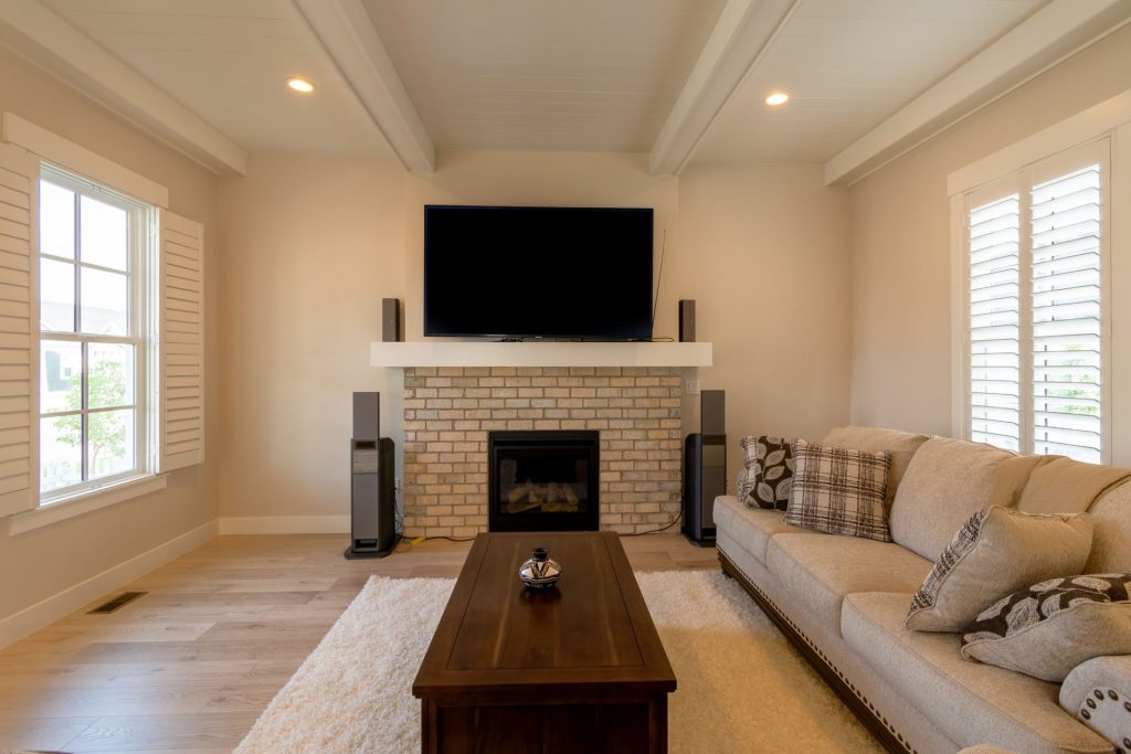 Spacious living room featuring a minimalist design with a cozy fireplace and modern furnishings.