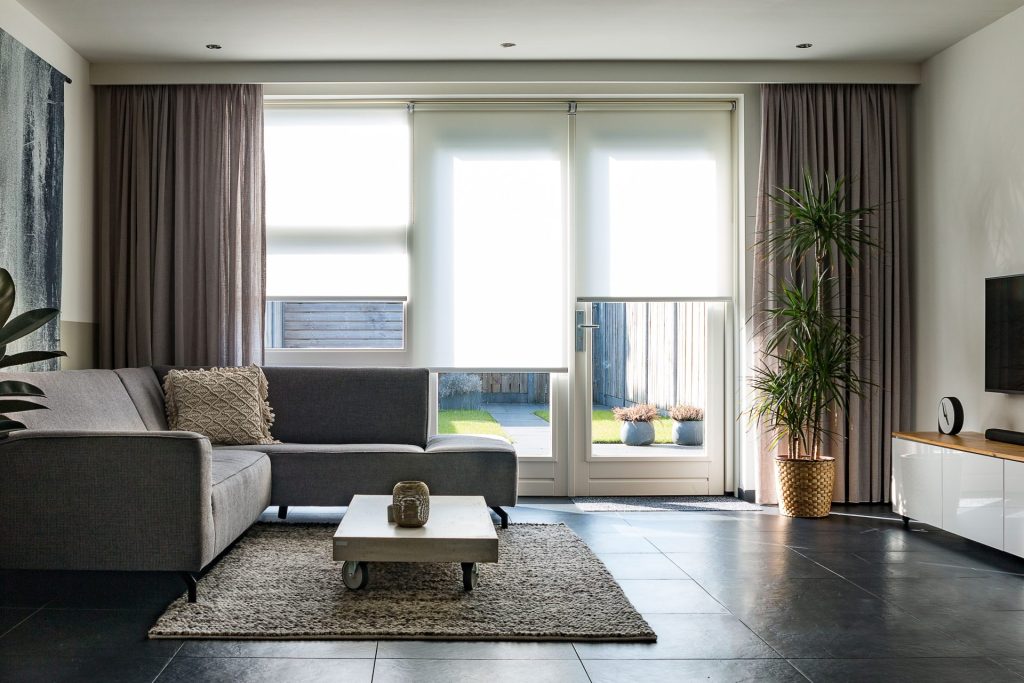 A modern living room with sleek furniture, natural light, and minimalist decor.