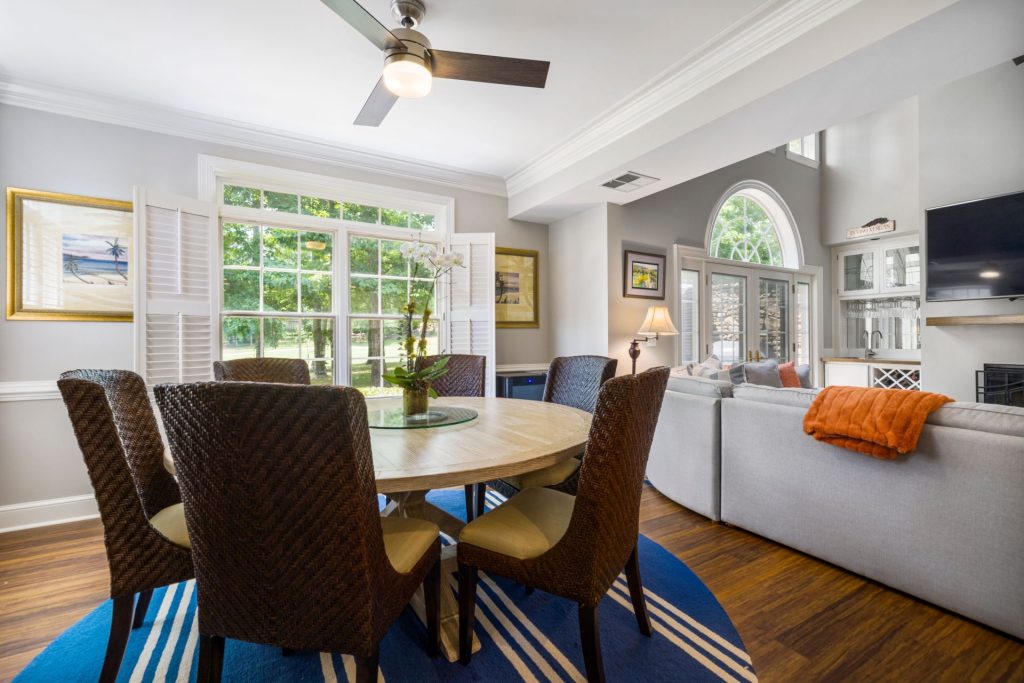 Spacious living room with elegant furniture, large windows, and charming decor.