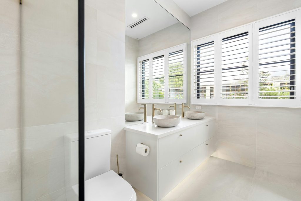 A bathroom with a toilet, sink, and shower